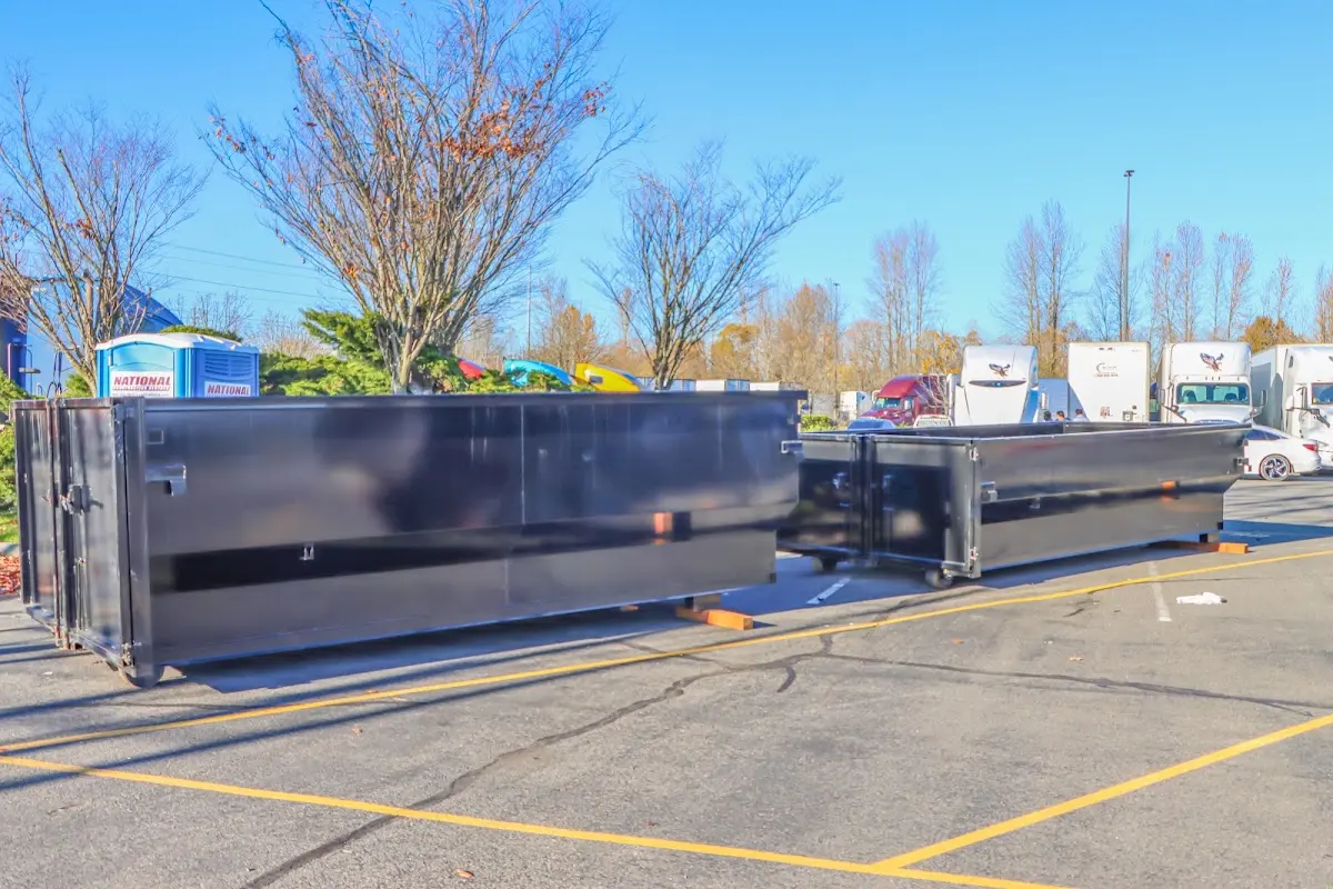 Professional dumpster rental service with roll-off container on residential driveway in Ithaca